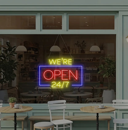 Stylish We Are Open 24/7 neon sign mounted on coffee shop glass door in red color.