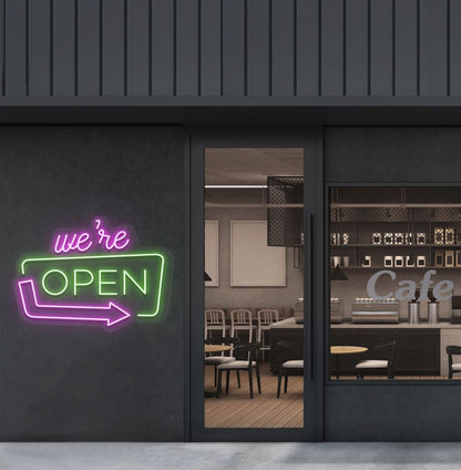 Cafe outdoor wall with a "We're Open" arrow neon sign glowing green. Perfect for café outdoor walls, storefront signage, restaurants, and commercial spaces.