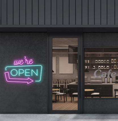 Image of a "We're Open" LED neon sign mounted on a cafe exterior wall with an arrow icon in ice blue color.
