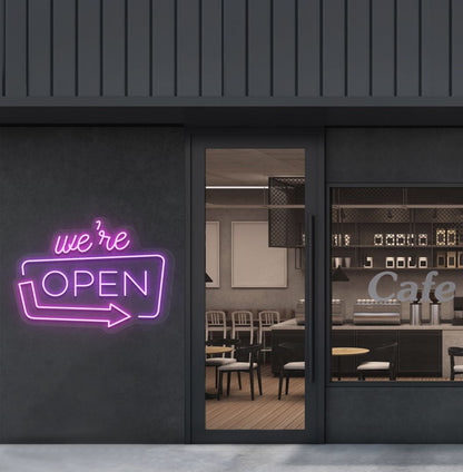 Cafe outdoor wall with a "We're Open" arrow neon sign glowing purple. Perfect for café outdoor walls, storefront signage, restaurants, and commercial spaces.