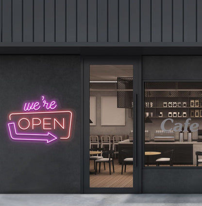 Image of a "We're Open" LED neon sign mounted on a cafe exterior wall with an arrow icon in red color.