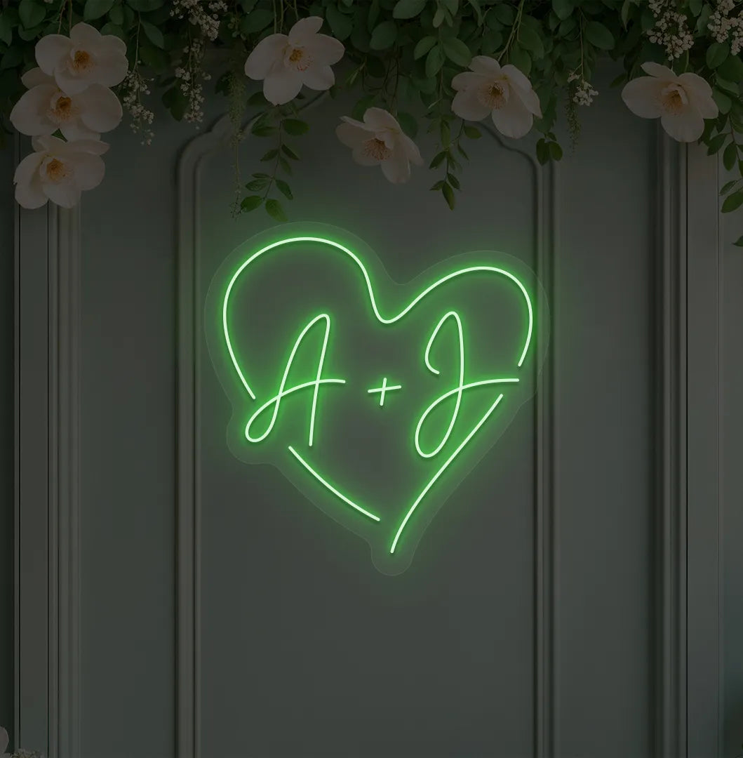 Image of a wedding initials neon sign glowing green on decorative wall.