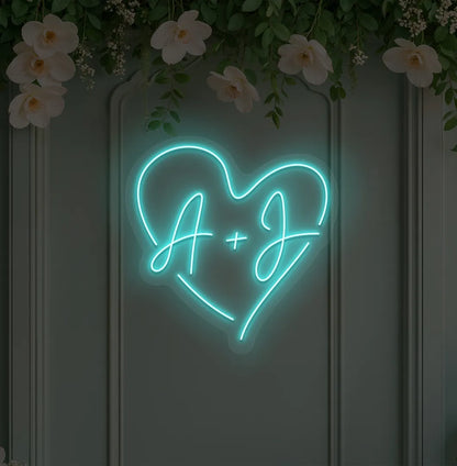wedding initials neon sign glowing ice blue on wedding backdrop.