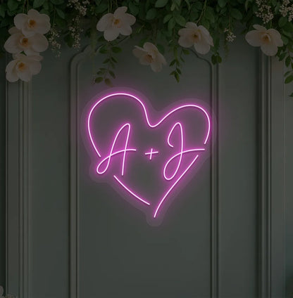 Image of a wedding initials neon sign glowing purple on decorative wall.