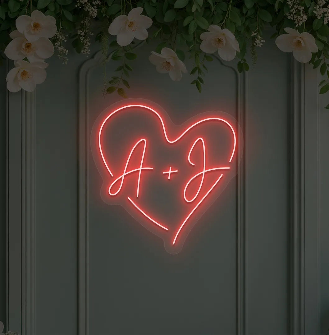 wedding initials neon sign glowing red on wedding backdrop.