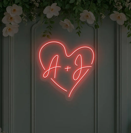 wedding initials neon sign glowing red on wedding backdrop.