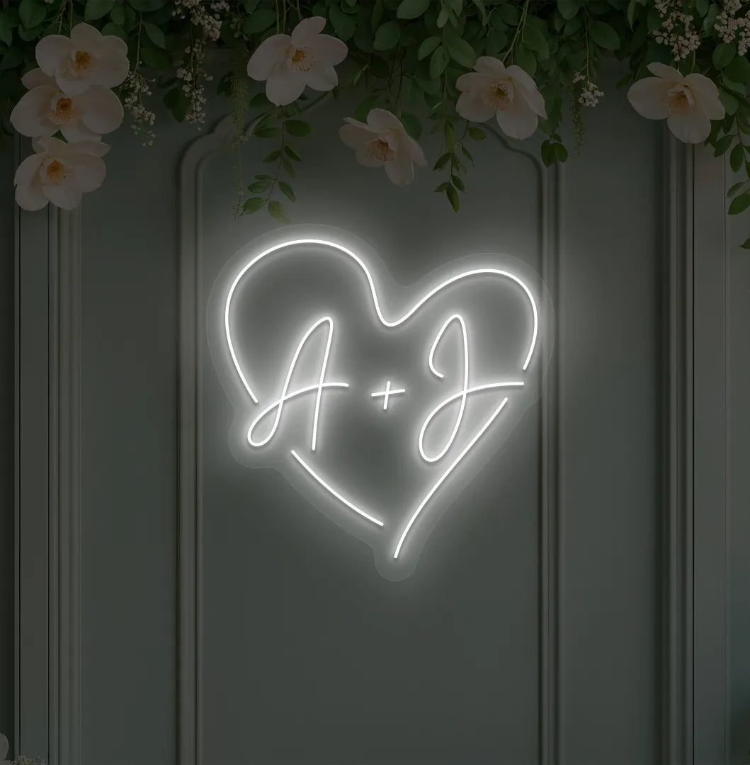 wedding initials neon sign glowing white on wedding backdrop.