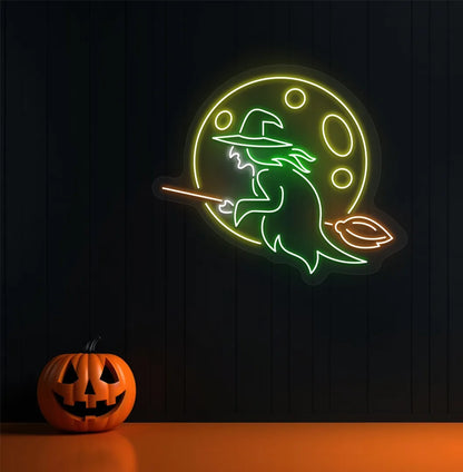 Witch Neon Sign illuminated in green on a spooky Halloween themed wall.