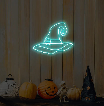 Witch Hat Neon Sign illuminated in ice blue on a spooky Halloween themed wall