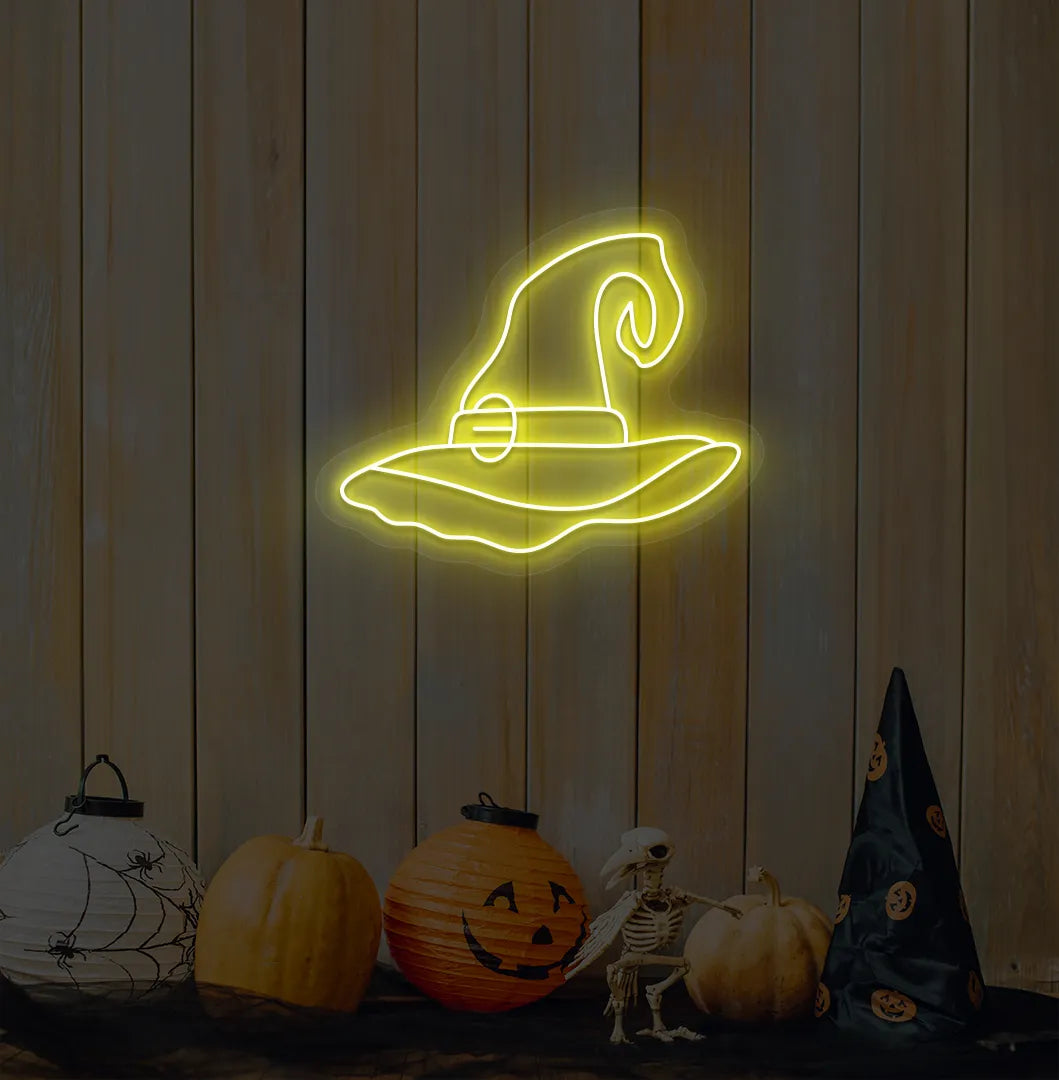 Witch Hat Neon Sign illuminated in yellow on a spooky Halloween themed wall