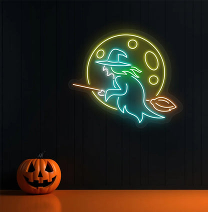 Witch LED neon sign with ice blue glow mounted on Halloween wall décor.