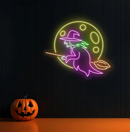 Witch LED neon sign with pink glow mounted on Halloween wall décor.