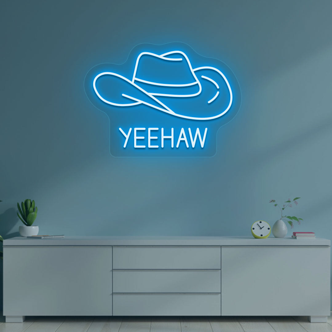 A western-style YEEHAW neon sign glowing ice blue on the wall. Perfect for living rooms, western-themed interiors, parties, and home bars.