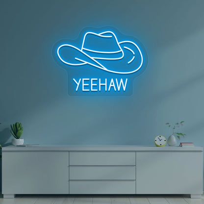A western-style YEEHAW neon sign glowing ice blue on the wall. Perfect for living rooms, western-themed interiors, parties, and home bars.
