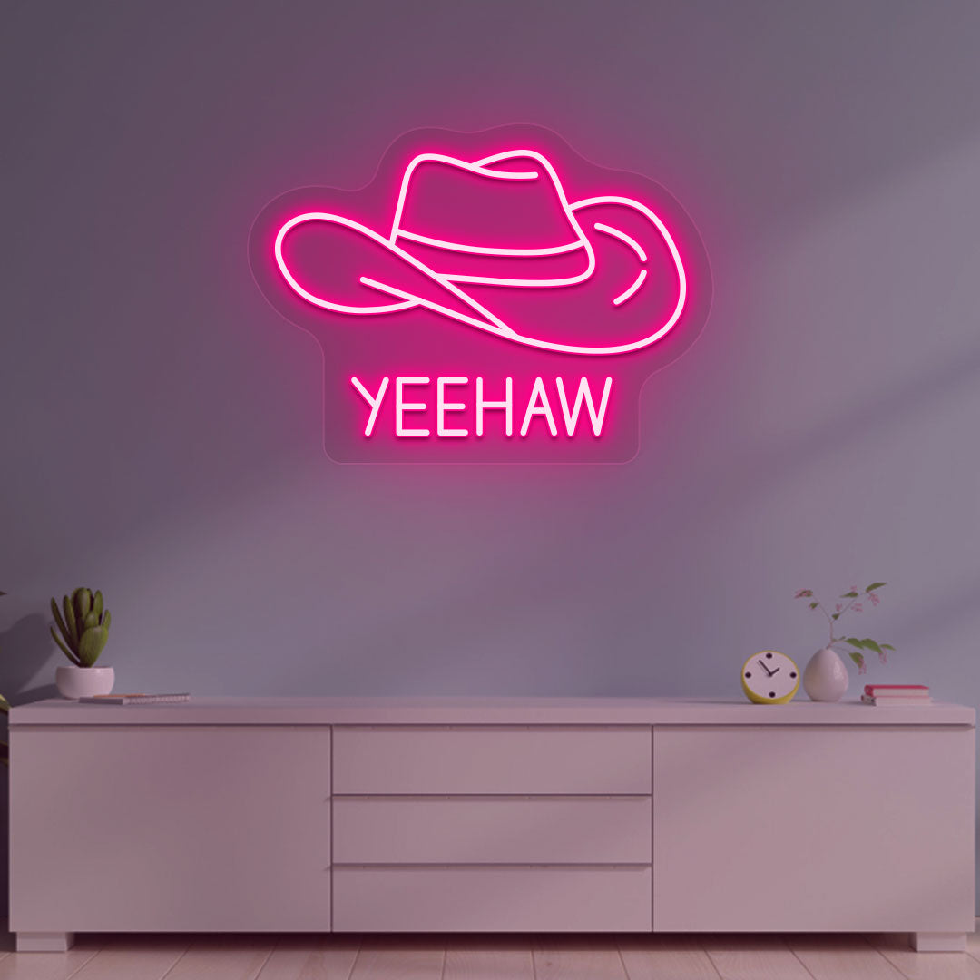 A western-style YEEHAW neon sign glowing pink on the wall. Perfect for living rooms, western-themed interiors, parties, and home bars.