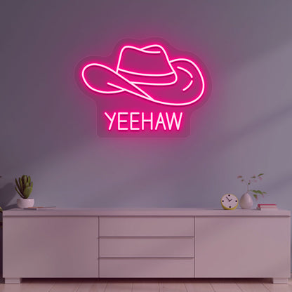 A western-style YEEHAW neon sign glowing pink on the wall. Perfect for living rooms, western-themed interiors, parties, and home bars.