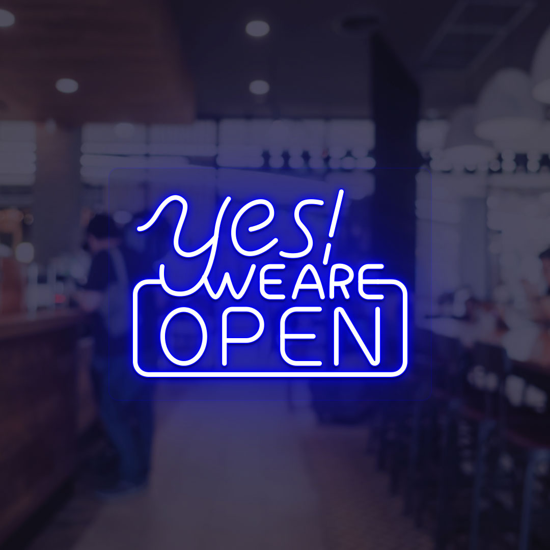Image of a "Yes, we are open" neon sign glowing on a shop door in blue color.