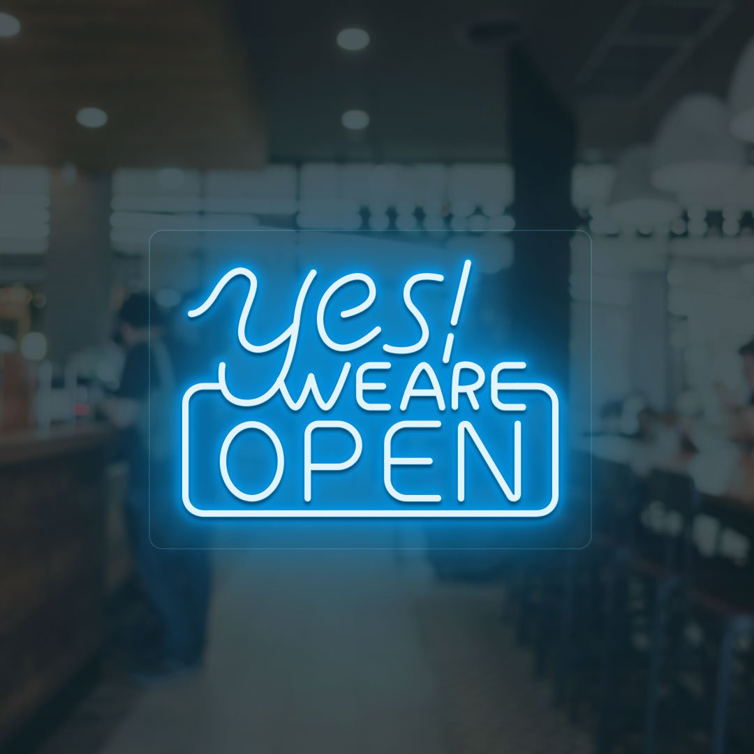 Yes, we are open neon sign in ice blue LED glowing on glass wall entrance. 