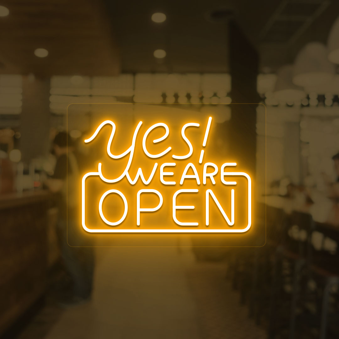 A storefront orange LED "Yes, we are open" neon sign mounted on a glass wall. perfect for retail shops, storefronts, and restaurants.