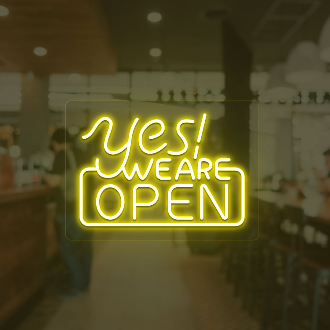 A storefront yellow LED "Yes, we are open" neon sign mounted on a glass wall. perfect for retail shops, storefronts, and restaurants.