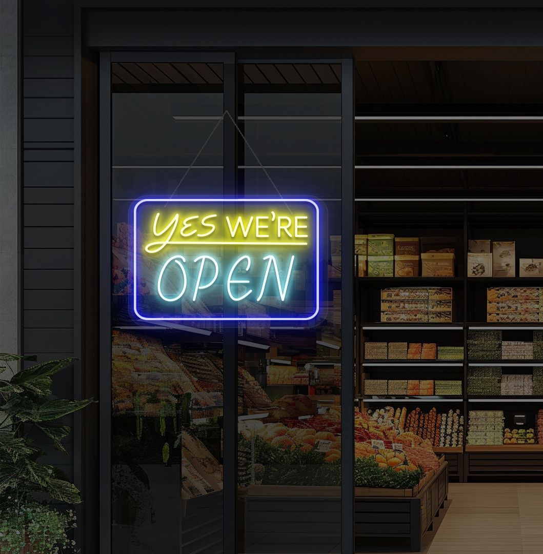 Image of a "Yes, we're open" neon sign glowing on a cafe glass door in ice blue color.
