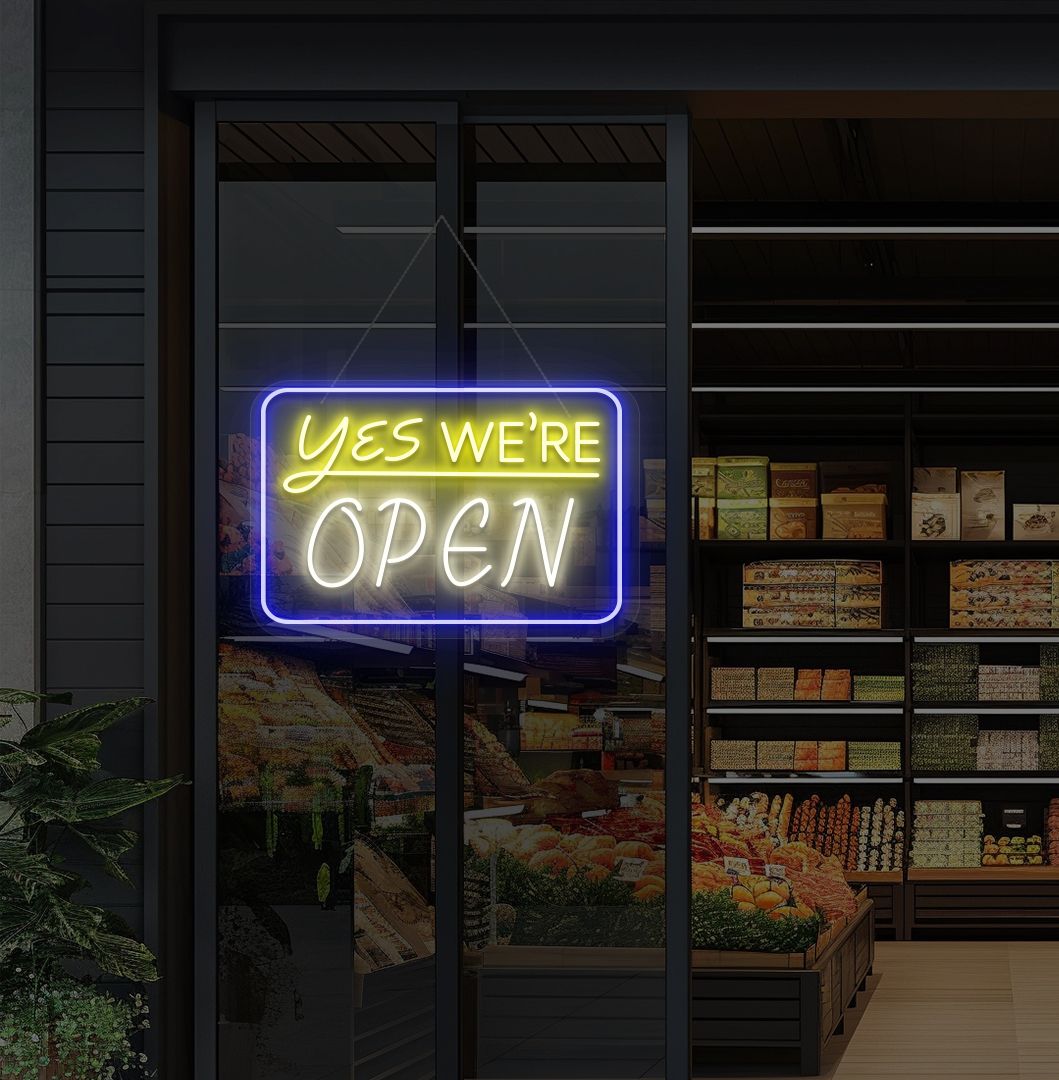 Modern, yes, we're open—an LED neon sign glowing warm white on the cafe door.