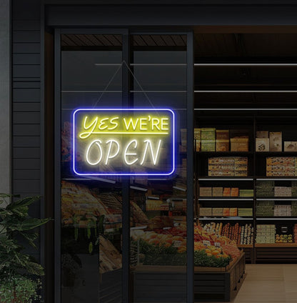 Modern, yes, we're open—an LED neon sign glowing warm white on the cafe door.