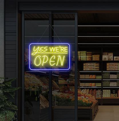 Modern, yes, we're open—an LED neon sign glowing yellow on the cafe door.