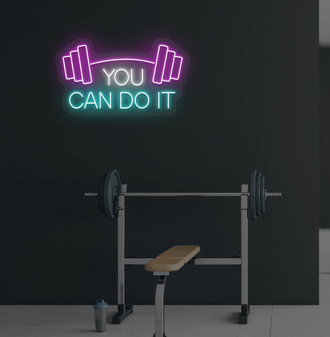 Image of a modern gym wall with you can do it dumbbell neon sign glowing ice blue.