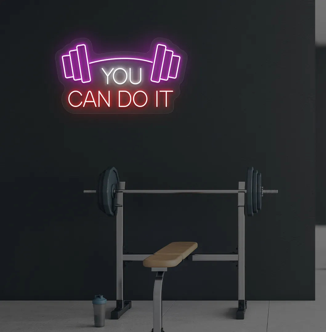 Image of a modern gym wall with you can do it dumbbell neon sign glowing red.