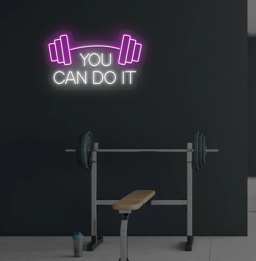 Image of a modern gym wall with you can do it dumbbell neon sign glowing white.