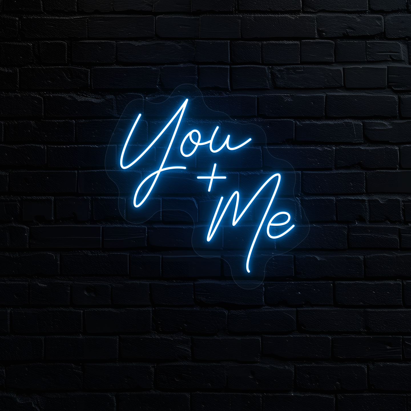 Image of a "you plus me" LED neon sign glowing on wall in ice blue.