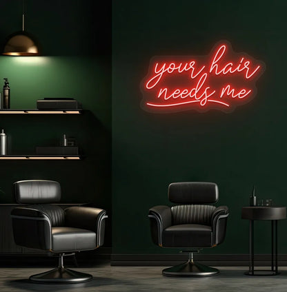Beauty salon interior with Your Hair Needs Me neon sign glowing red.