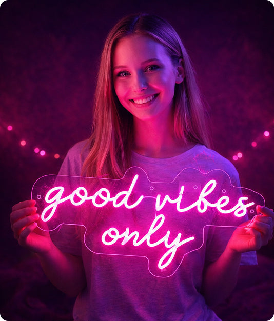 Person holding a neon sign with 'good vibes only' text against a dark background